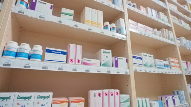 DS Neatly stacked medicine on the shelves at the drugstore