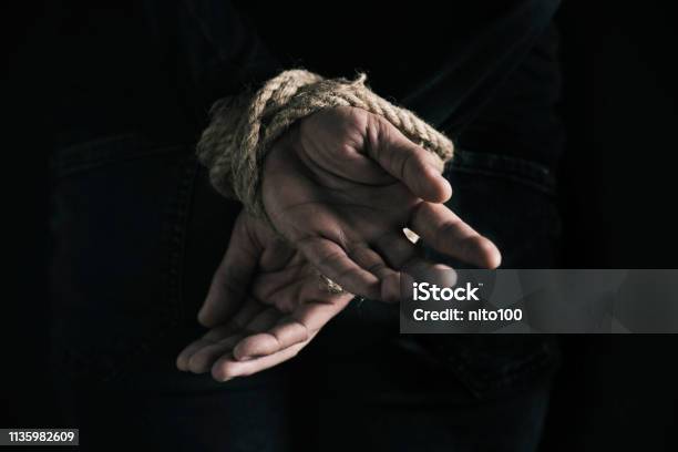 Man With His Hands Tied Behind His Back Stock Photo - Download Image Now - Kidnapping, Tied Up, Torture
