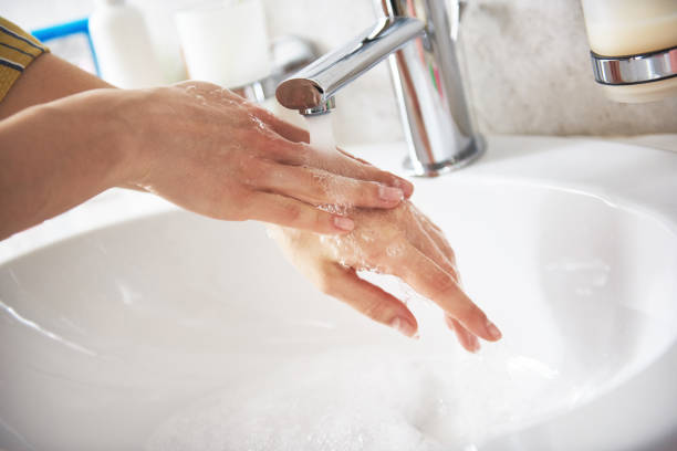 istock Lady washing her hands by water from tap 1135983037