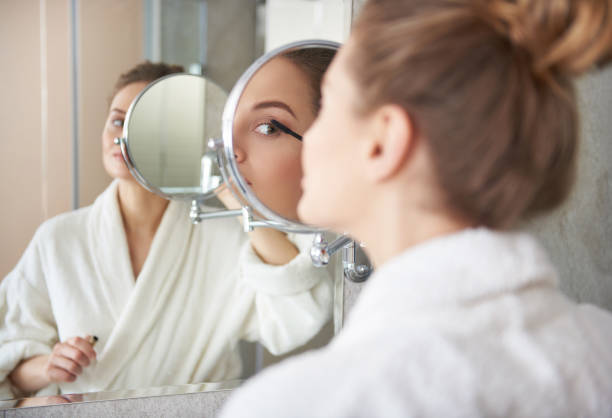 istock Back side of young lady putting on mascara 1135983048