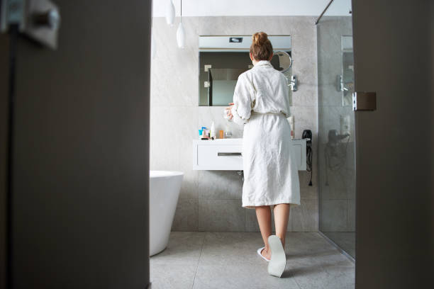 istock Back side of young lady looking at mirror 1135983055