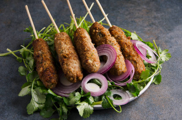 istock Closeup of kebab with spices,onion rings on dark rustic kitchen table 1135983857
