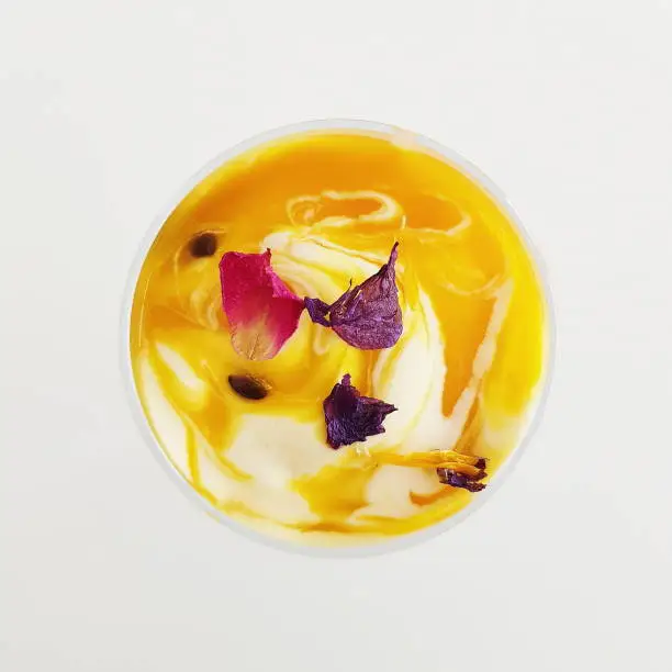 Pictures taken for a recipe shoot. Passion fruit mousse in a martini glass with passionfruit coulis.