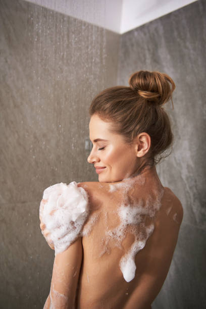 junge glückliche dame duscht zu hause - dusche stock-fotos und bilder