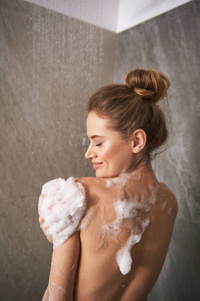 istock Young happy lady taking shower at home 1135986019