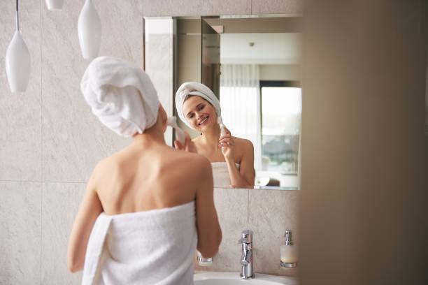 istock Young lady wrapping in towel cleaning face 1135986032