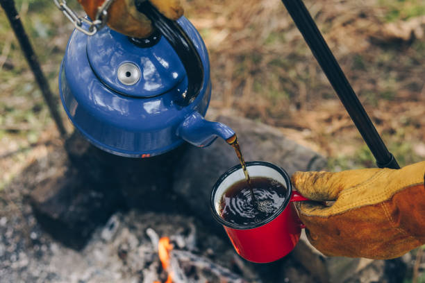istock Pouring of tea from a thermos on a camping 1135986162