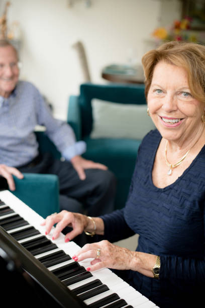 istock Senior woman playing the piano 1135986483