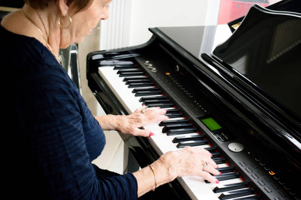 istock Senior woman playing the piano 1135986506