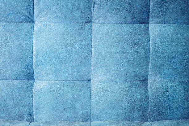 istock Close-up comfortable blue soft back of the sofa with curly stitching. Modern design 1135988488