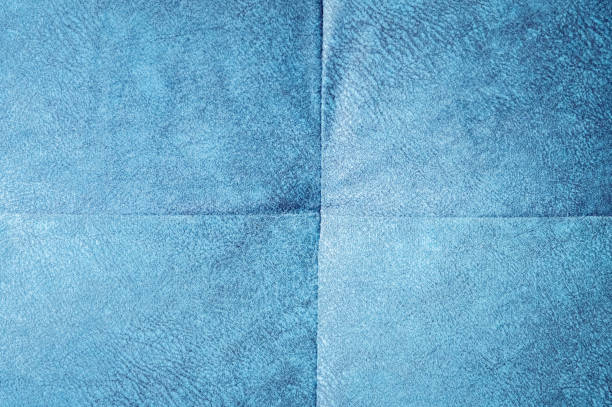 istock Close-up comfortable blue soft back of the sofa with curly stitching. Modern design 1135988497