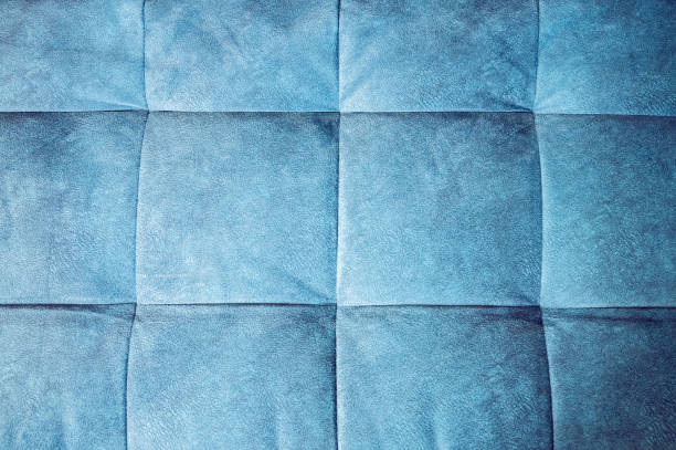 istock Close-up comfortable blue soft back of the sofa with curly stitching. Modern design 1135988507