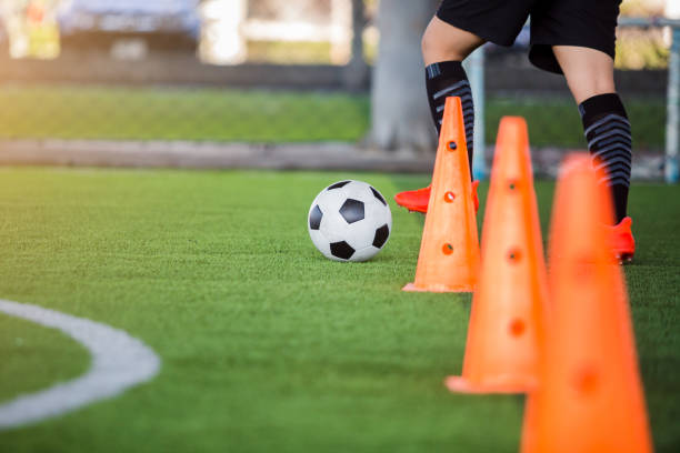 istock soccer player jogging with trap and control football 1135988647