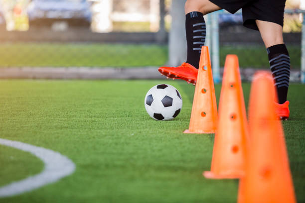 istock soccer player jogging with trap and control football 1135988821