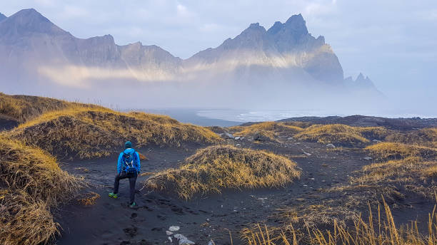 istock Iceland - Man and tall mountains 1135990955