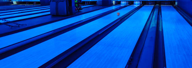 istock Bowling alley lit with blue lights. 1135993403