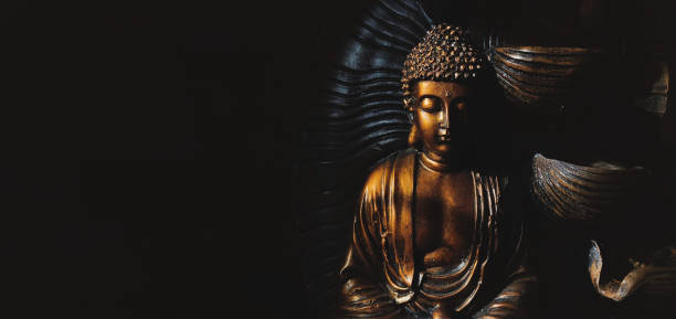 Golden Gautama Buddha Statue With A Black Background Depicting Darkness And  Hope Stock Photo - Download Image Now - iStock