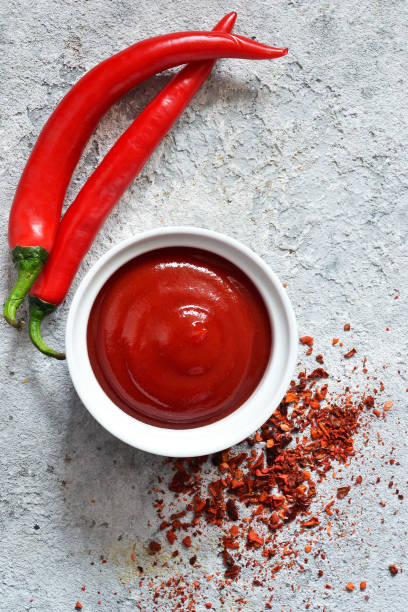 istock Classic tomato sauce with spices on a concrete background. View from above. 1135993644