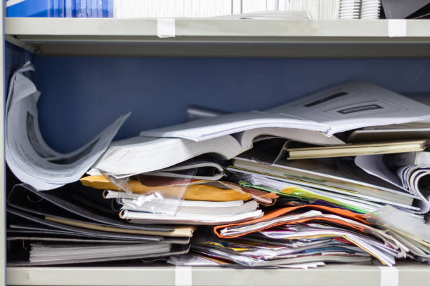 istock Messy file document and Office Supplies in filing cabinets at work office 1135994789