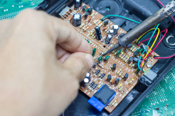istock Technician repairing electronic of the computer circuit board by soldering Irons 1135994800