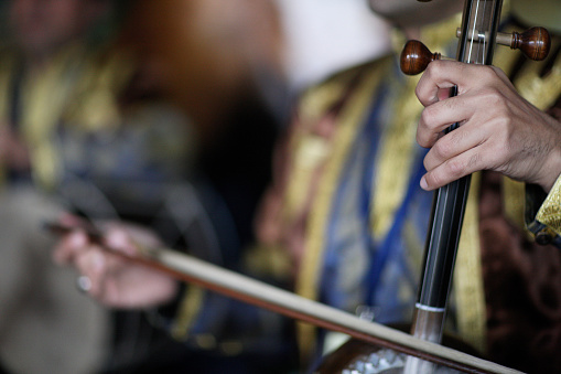 The musician plays on national stringed bow instrument.