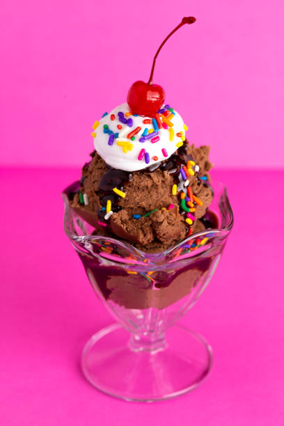 istock Chocolate Sundae with Sprinkles and a Cherry on a Pink Background 1136006574