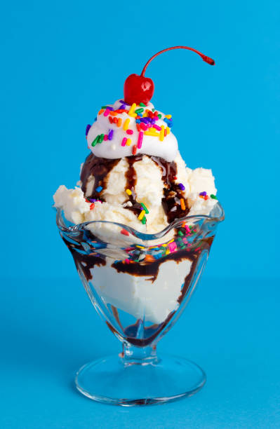istock A Vanilla Sundae with Rainbow Sprinkles on a Blue Background 1136007277