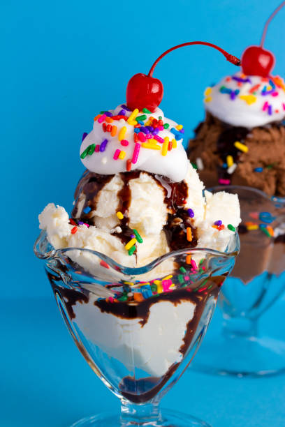istock A Vanilla and Chocolate Sundae with Sprinkles on a Blue Background 1136008442
