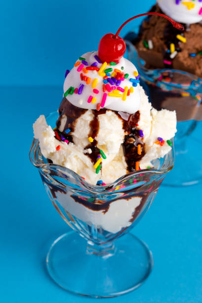 istock A Vanilla and Chocolate Sundae with Sprinkles on a Blue Background 1136008617