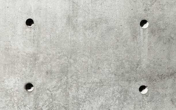istock Texture of concrete wall with four small holes 1136009587