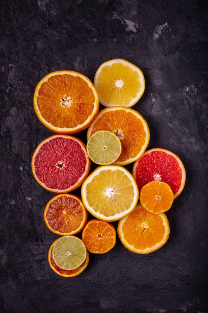 istock Various types of citrus fruit cut into slices on a dark background 1136009745