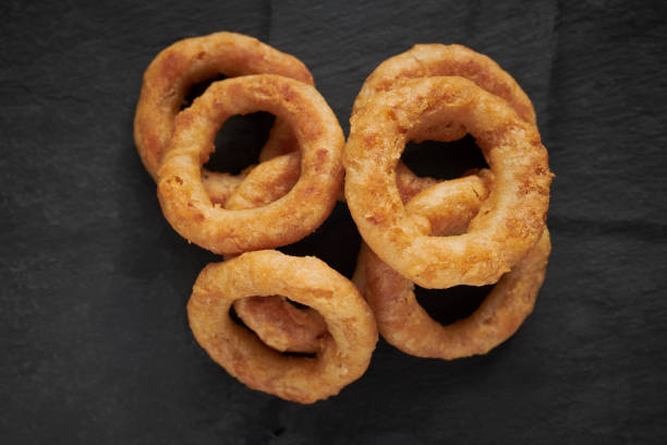 istock Stack of onion rings on a slate background from above. 1136011707