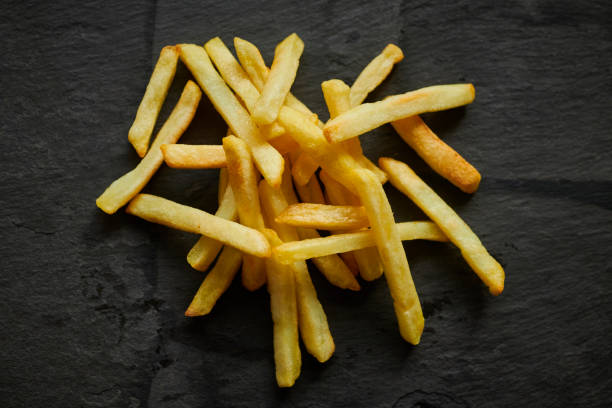 istock Stack of French fries on a slate background from above. 1136011724