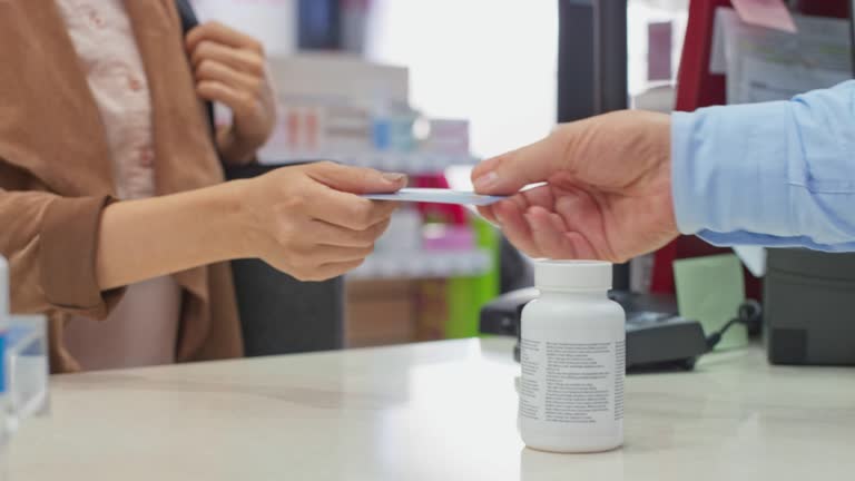 LD Female customer paying with a contactless card at the drugstore