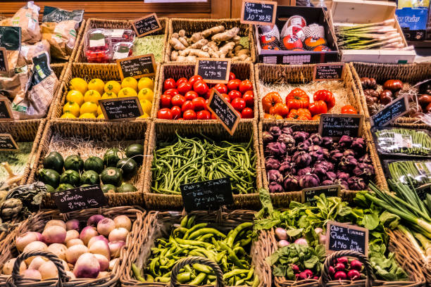 fruit and vegetables at the counter of a covered market - leaf vegetable freshness vegetable market imagens e fotografias de stock