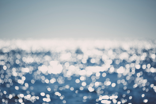 Blue Sparkling ocean defocussed with bokeh background, shot in the Atlantic Ocean off the coast of Cornwall UK