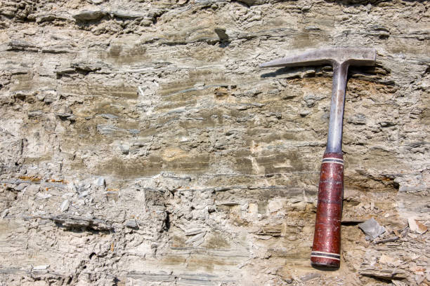 Geological hammer on the rocks Geological hammer on the rocks paleontologist stock pictures, royalty-free photos & images