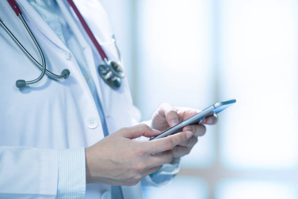 istock Medical doctor using smart phone for work in hospital 1136017506