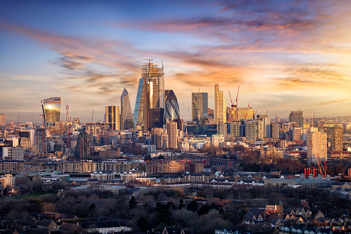 Sunrise over the urban skyline of the City of London, UK, financial district and hub of banking institutions