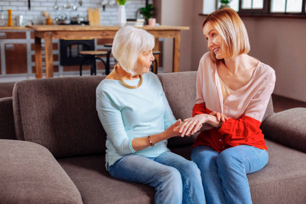 istock Elegant pensioner examining beautiful engagement ring of her relative 1136021199