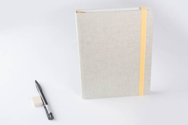 istock closed notepad with bookmarks of tape, pencil and eraser on a white background 1136023310