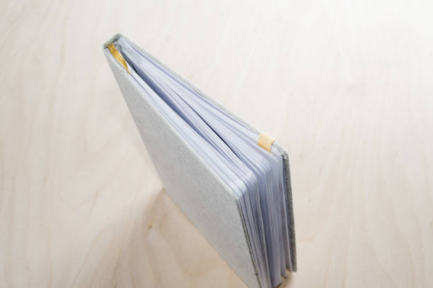 istock closed notepad with bookmarks of tape on a wooden background 1136023319