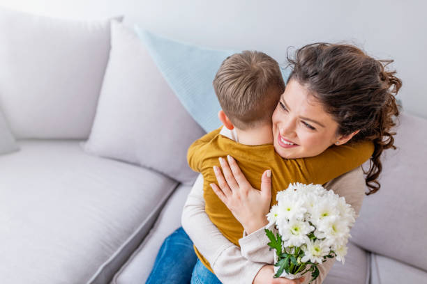 istock Cheerful little boy with flower as a gift. 1136024529