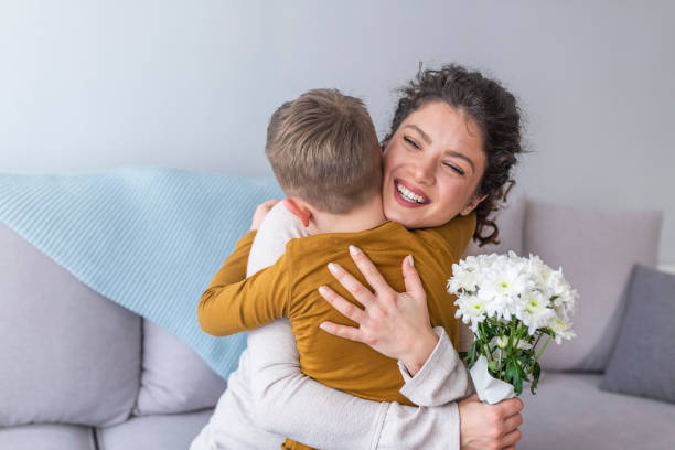 istock Cheerful little boy with flower as a gift. 1136026145