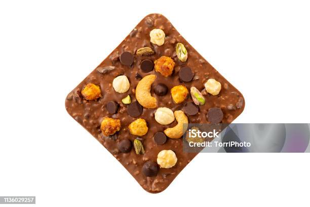 Milk Chocolate Bar With Hazelnuts Pistachio And Cashew Isolated On White Background Stock Photo - Download Image Now