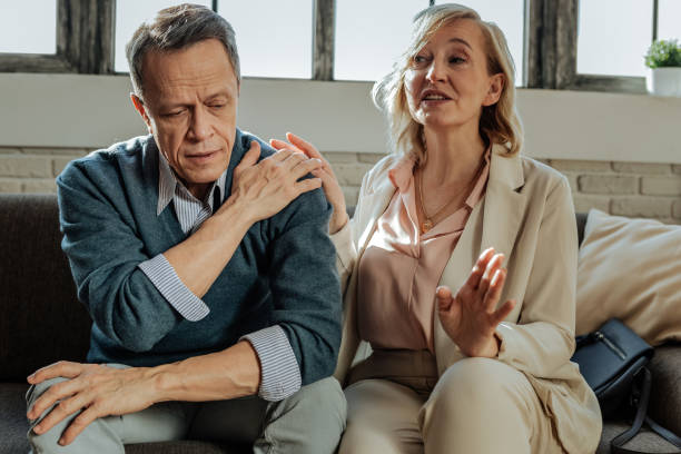 istock Expressive blonde wife in light outfit calming her husband down 1136029594