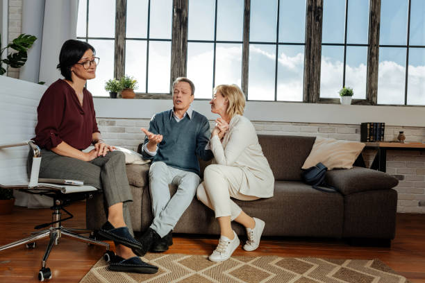 istock Expressive good-looking couple sitting next to each other and talking about themselves 1136029620