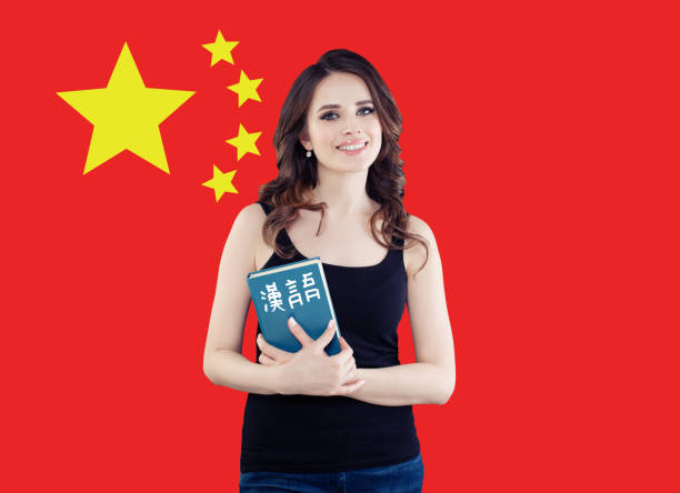 Speak chinese concept. Happy woman against the People's Republic of China flag background Speak chinese concept. Happy woman against the People's Republic of China flag background prc stock pictures, royalty-free photos & images