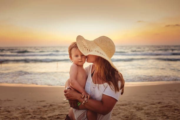 Mother with son enjoying sunset on the beach