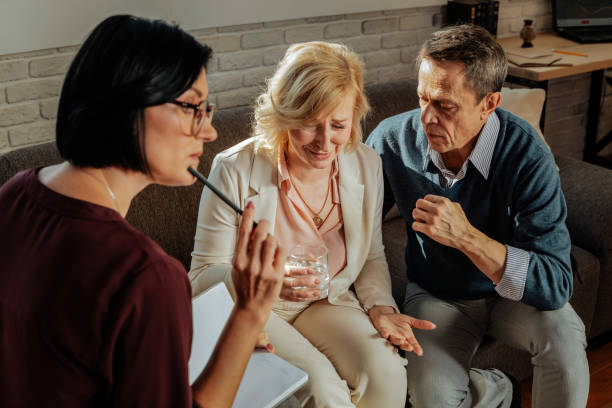 istock Crying depressed blonde woman having mental issues and visiting therapist 1136033162
